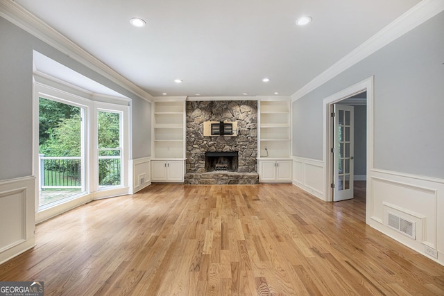 386 Link Rd, Alpharetta, GA 30022 - unfurnished living room with built in features, ornamental molding, a stone fireplace, light wood-style floors, and recessed lighting