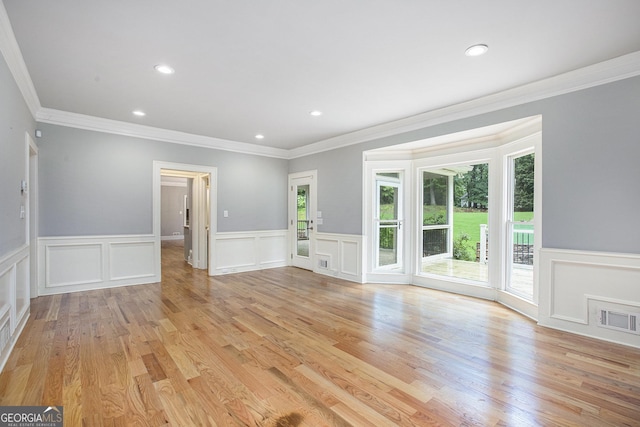 386 Link Rd, Alpharetta, GA 30022 - unfurnished living room featuring crown molding, a decorative wall, a wainscoted wall, recessed lighting, and light wood finished floors