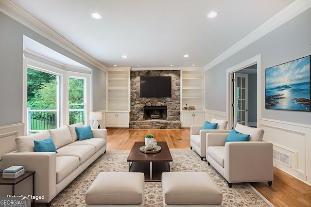 386 Link Rd, Alpharetta, GA 30022 - living room with crown molding, wood finished floors, built in shelves, a wainscoted wall, and recessed lighting