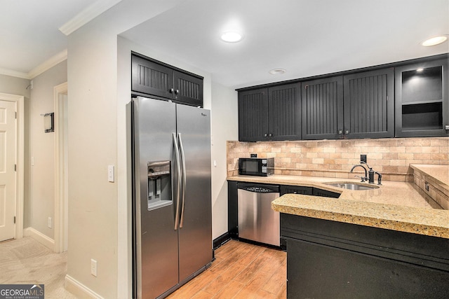 386 Link Rd, Alpharetta, GA 30022 - kitchen with stainless steel appliances, a sink, ornamental molding, backsplash, and light stone countertops
