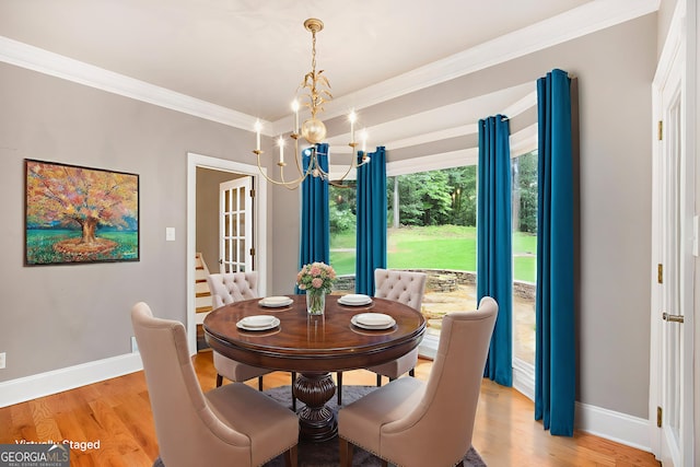 386 Link Rd, Alpharetta, GA 30022 - dining area featuring a chandelier, baseboards, crown molding, and light wood finished floors