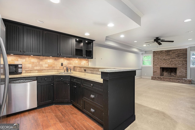 386 Link Rd, Alpharetta, GA 30022 - kitchen with stainless steel dishwasher, a sink, a peninsula, crown molding, and a ceiling fan