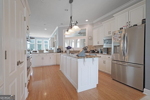 12 Par Dr, Jesup, GA 31546 - kitchen with stainless steel appliances, white cabinets, light wood finished floors, ornamental molding, and recessed lighting