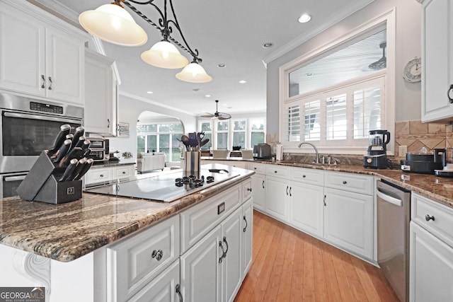 12 Par Dr, Jesup, GA 31546 - kitchen with black electric cooktop, stainless steel dishwasher, white cabinetry, ceiling fan, and crown molding