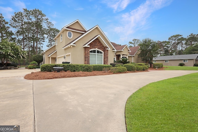 12 Par Dr, Jesup, GA 31546 - traditional-style house with driveway, stucco siding, stone siding, and a front yard
