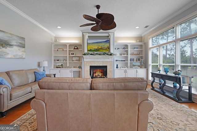 12 Par Dr, Jesup, GA 31546 - living area with a ceiling fan, wood finished floors, a tile fireplace, ornamental molding, and recessed lighting