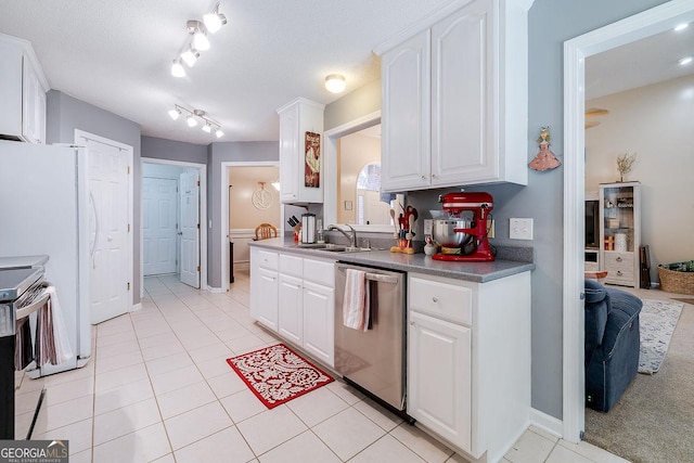 79 Churchill Ct, Richmond Hill, GA 31324 - kitchen with appliances with stainless steel finishes, light tile patterned floors, white cabinets, and track lighting