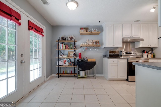 79 Churchill Ct, Richmond Hill, GA 31324 - kitchen with under cabinet range hood, stainless steel electric stove, white cabinets, open shelves, and dark countertops