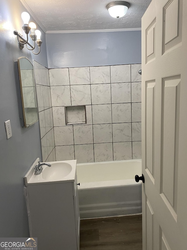 525 Ormond Ter, Macon, GA 31206 - full bathroom with wood finished floors, vanity, crown molding, a textured ceiling, and shower / bathtub combination