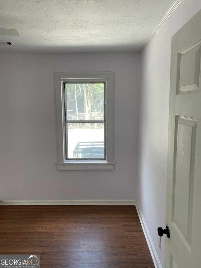 525 Ormond Ter, Macon, GA 31206 - unfurnished room featuring dark wood-style floors, a textured ceiling, and baseboards