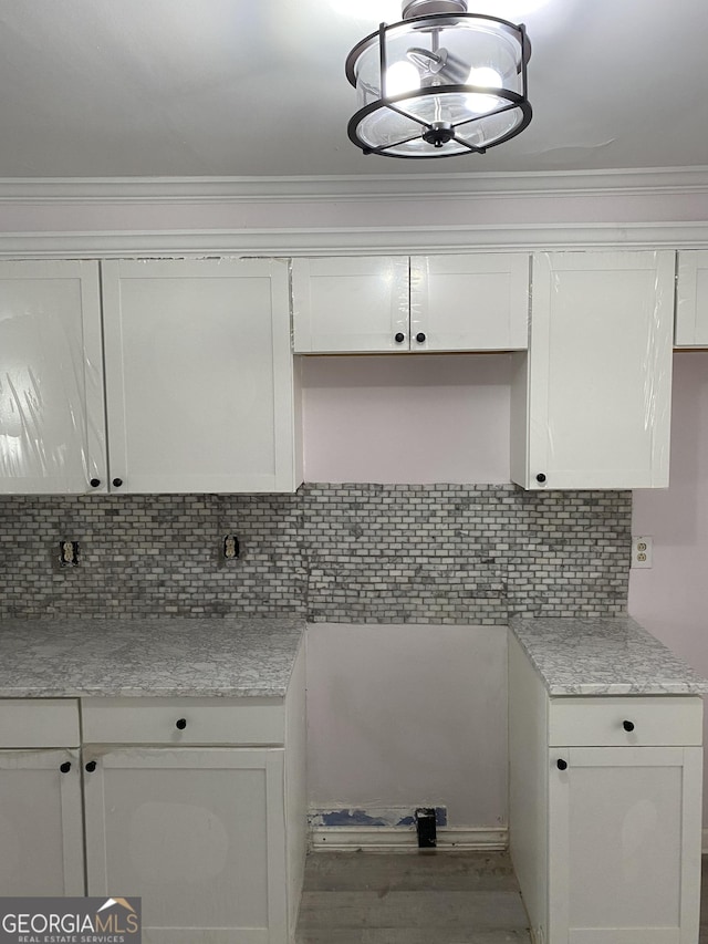 525 Ormond Ter, Macon, GA 31206 - kitchen featuring white cabinets, backsplash, ornamental molding, and wood finished floors