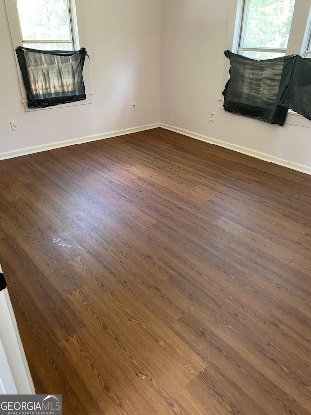 525 Ormond Ter, Macon, GA 31206 - unfurnished room with healthy amount of natural light, dark wood-style flooring, and baseboards
