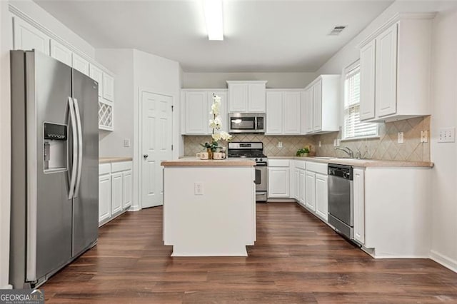 606 Hay Meadow Pl, Acworth, GA 30102 - kitchen featuring stainless steel appliances, light countertops, white cabinets, a kitchen island, and tasteful backsplash