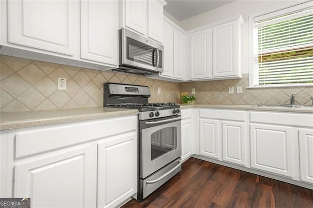 606 Hay Meadow Pl, Acworth, GA 30102 - kitchen with stainless steel appliances, a sink, light countertops, and white cabinetry