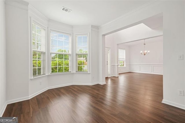 606 Hay Meadow Pl, Acworth, GA 30102 - empty room with a chandelier, healthy amount of natural light, ornamental molding, dark wood-style floors, and baseboards