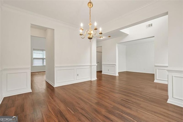 606 Hay Meadow Pl, Acworth, GA 30102 - unfurnished dining area with a chandelier, ornamental molding, dark wood-type flooring, a wainscoted wall, and a decorative wall