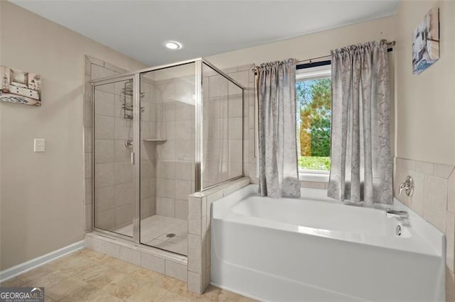 1709 Grove Ct, Conyers, GA 30013 - full bathroom featuring a stall shower, a bath, baseboards, and recessed lighting