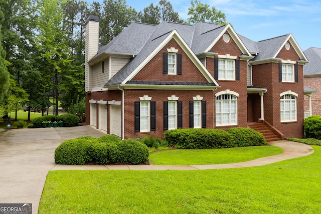 1014 Overlook Dr, Villa Rica, GA 30180 - colonial-style house featuring brick siding, driveway, a chimney, a front yard, and roof with shingles