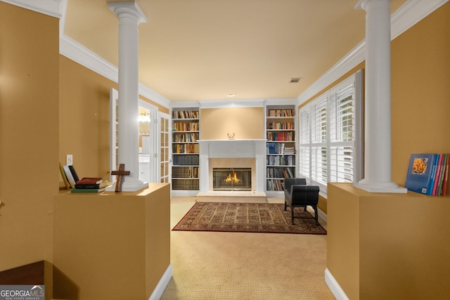1014 Overlook Dr, Villa Rica, GA 30180 - living area featuring decorative columns, a glass covered fireplace, crown molding, carpet floors, and baseboards
