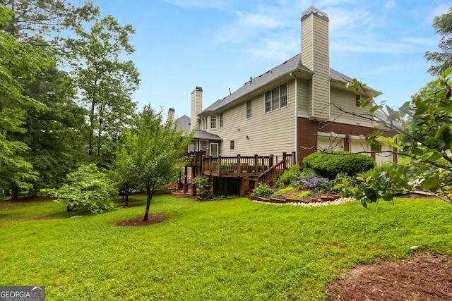 1014 Overlook Dr, Villa Rica, GA 30180 - back of property featuring a deck, brick siding, a chimney, and a lawn