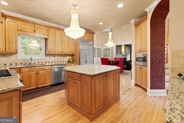 1014 Overlook Dr, Villa Rica, GA 30180 - kitchen featuring built in appliances, a sink, a center island, light wood finished floors, and light stone countertops