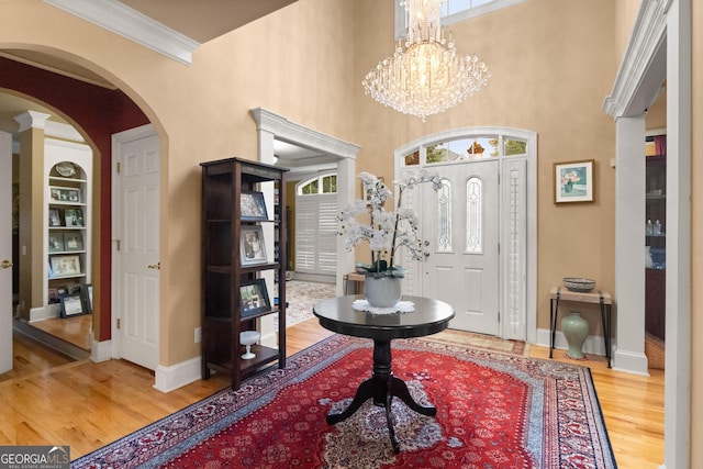 1014 Overlook Dr, Villa Rica, GA 30180 - foyer entrance featuring wood finished floors, arched walkways, baseboards, ornamental molding, and plenty of natural light
