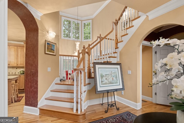 1014 Overlook Dr, Villa Rica, GA 30180 - stairs with arched walkways, wood finished floors, crown molding, and baseboards