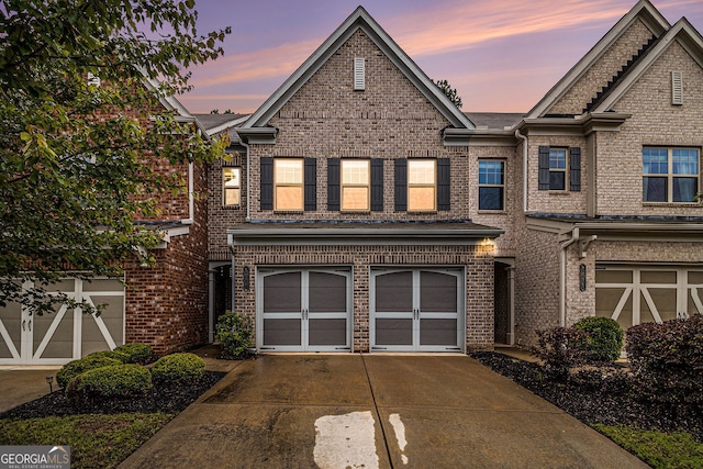 1425 Hampton Oaks Dr, Alpharetta, GA 30004 - view of property featuring an attached garage, concrete driveway, and brick siding