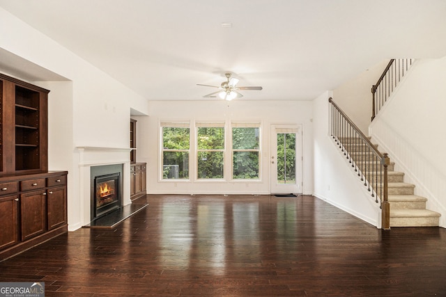 1425 Hampton Oaks Dr, Alpharetta, GA 30004 - unfurnished living room featuring ceiling fan, hardwood / wood-style floors, a glass covered fireplace, stairway, and baseboards