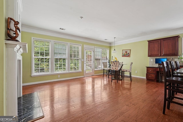 251 Sumac Trl, Woodstock, GA 30188 - dining area with healthy amount of natural light, crown molding, and dark wood-style flooring