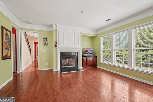 251 Sumac Trl, Woodstock, GA 30188 - unfurnished living room featuring a fireplace, ornamental molding, and wood finished floors