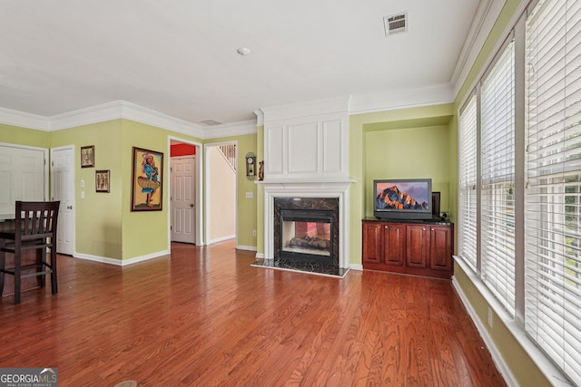 251 Sumac Trl, Woodstock, GA 30188 - living area featuring plenty of natural light, dark wood-style flooring, a fireplace, and crown molding