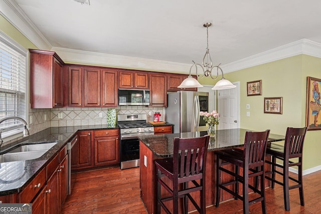 251 Sumac Trl, Woodstock, GA 30188 - kitchen with stainless steel appliances, dark wood-style flooring, backsplash, a center island, and ornamental molding
