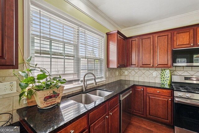 251 Sumac Trl, Woodstock, GA 30188 - kitchen with stainless steel appliances, dark brown cabinets, ornamental molding, decorative backsplash, and dark stone counters