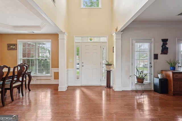 251 Sumac Trl, Woodstock, GA 30188 - foyer entrance with ornate columns, plenty of natural light, wood finished floors, crown molding, and wainscoting