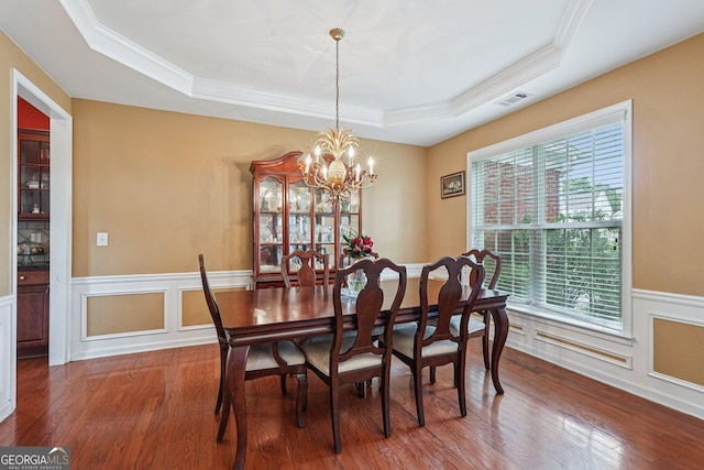 251 Sumac Trl, Woodstock, GA 30188 - dining area featuring a tray ceiling, healthy amount of natural light, wood finished floors, a chandelier, and ornamental molding