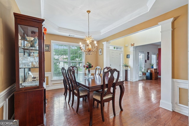 251 Sumac Trl, Woodstock, GA 30188 - dining room featuring a tray ceiling, ornamental molding, a chandelier, a decorative wall, and wood finished floors