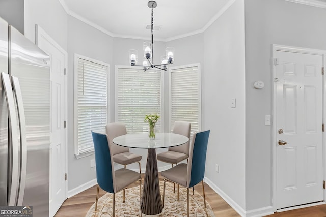 3315 Brookfield Dr, Austell, GA 30106 - dining space featuring a chandelier, wood finished floors, crown molding, and baseboards