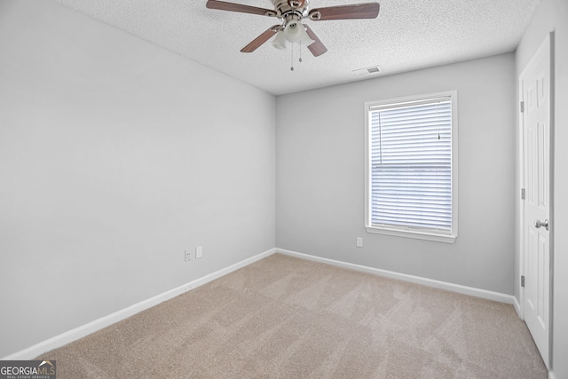 3315 Brookfield Dr, Austell, GA 30106 - empty room featuring a textured ceiling, carpet floors, a ceiling fan, and baseboards