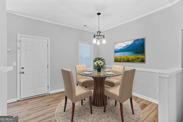 3315 Brookfield Dr, Austell, GA 30106 - dining space with light wood-type flooring, a chandelier, baseboards, and crown molding