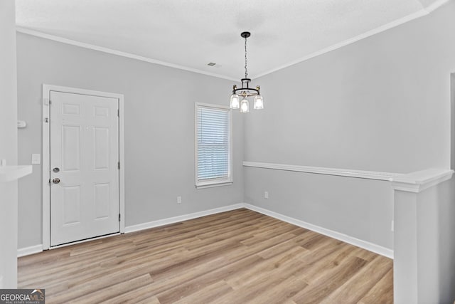 3315 Brookfield Dr, Austell, GA 30106 - unfurnished dining area with a chandelier, light wood finished floors, crown molding, and baseboards