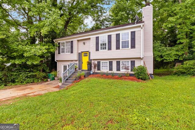 4651 Garden Hills Dr, Stone Mountain, GA 30083 - bi-level home with a chimney and a front lawn
