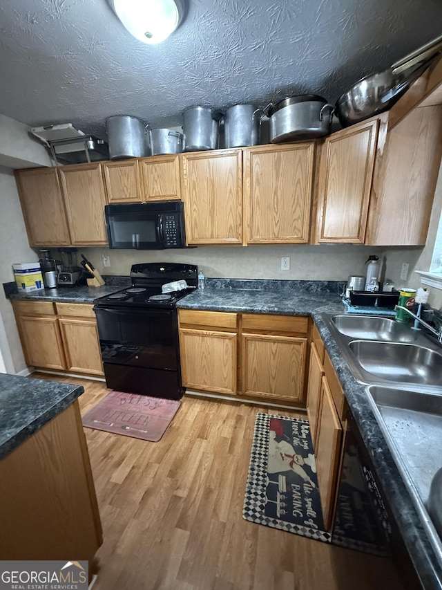6550 Wellington Chase Ct, Lithonia, GA 30058 - kitchen with black appliances, light wood-type flooring, and dark countertops
