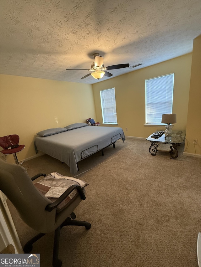 6550 Wellington Chase Ct, Lithonia, GA 30058 - bedroom with a textured ceiling, carpet flooring, baseboards, and ceiling fan