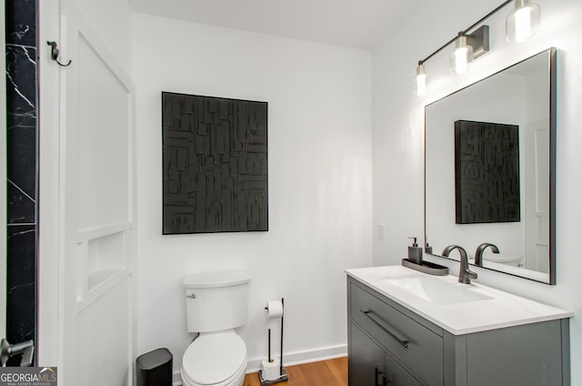 778 Laurel Cove Dr, Hoschton, GA 30548 - bathroom featuring toilet, vanity, wood finished floors, and baseboards