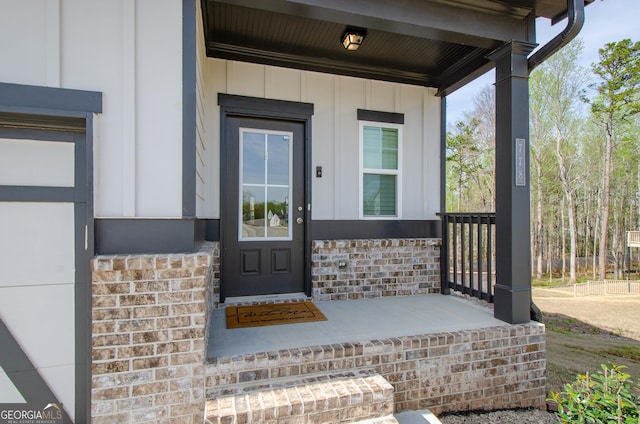 778 Laurel Cove Dr, Hoschton, GA 30548 - doorway to property featuring covered porch and board and batten siding