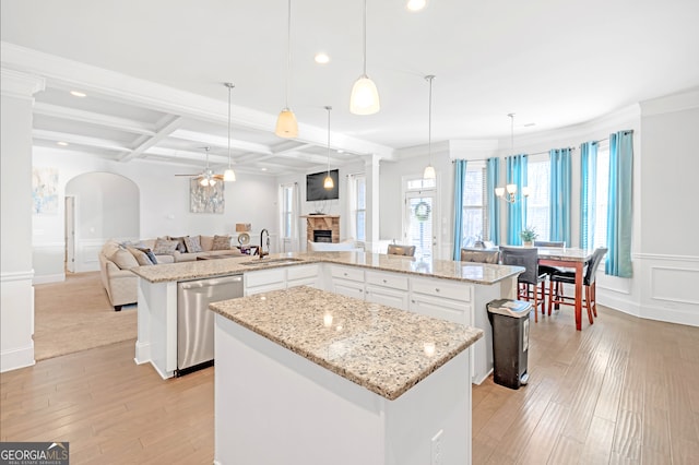 4580 Cloister Cir, Hampton, GA 30228 - kitchen featuring dishwasher, a kitchen island, open floor plan, coffered ceiling, and arched walkways