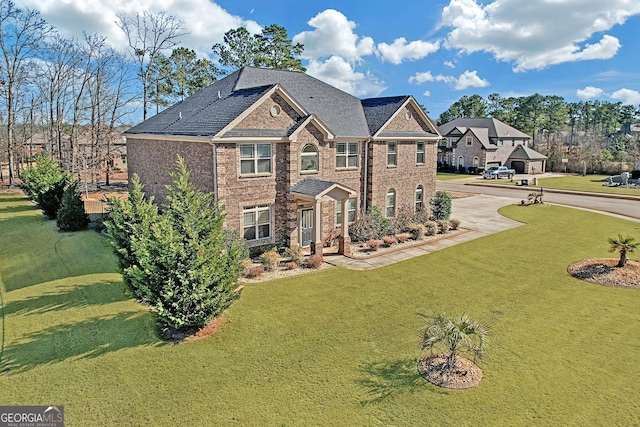 4580 Cloister Cir, Hampton, GA 30228 - view of front of home featuring brick siding, a front lawn, and driveway