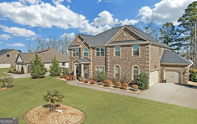 4580 Cloister Cir, Hampton, GA 30228 - view of front of house featuring concrete driveway, a front lawn, a garage, and brick siding
