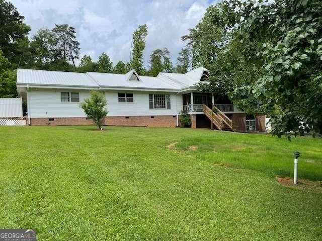 1470 Dunn Rd, Cumming, GA 30040 - back of house with crawl space, stairs, and a lawn